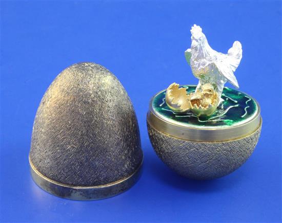 A cased early 1980s Stuart Devlin silver gilt surprise egg, 2.75in.